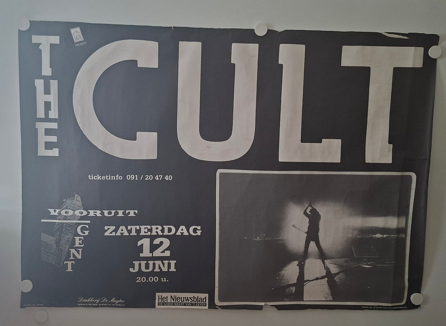 Poster for 'The Cult' concert featuring a silhouette of a person on stage.